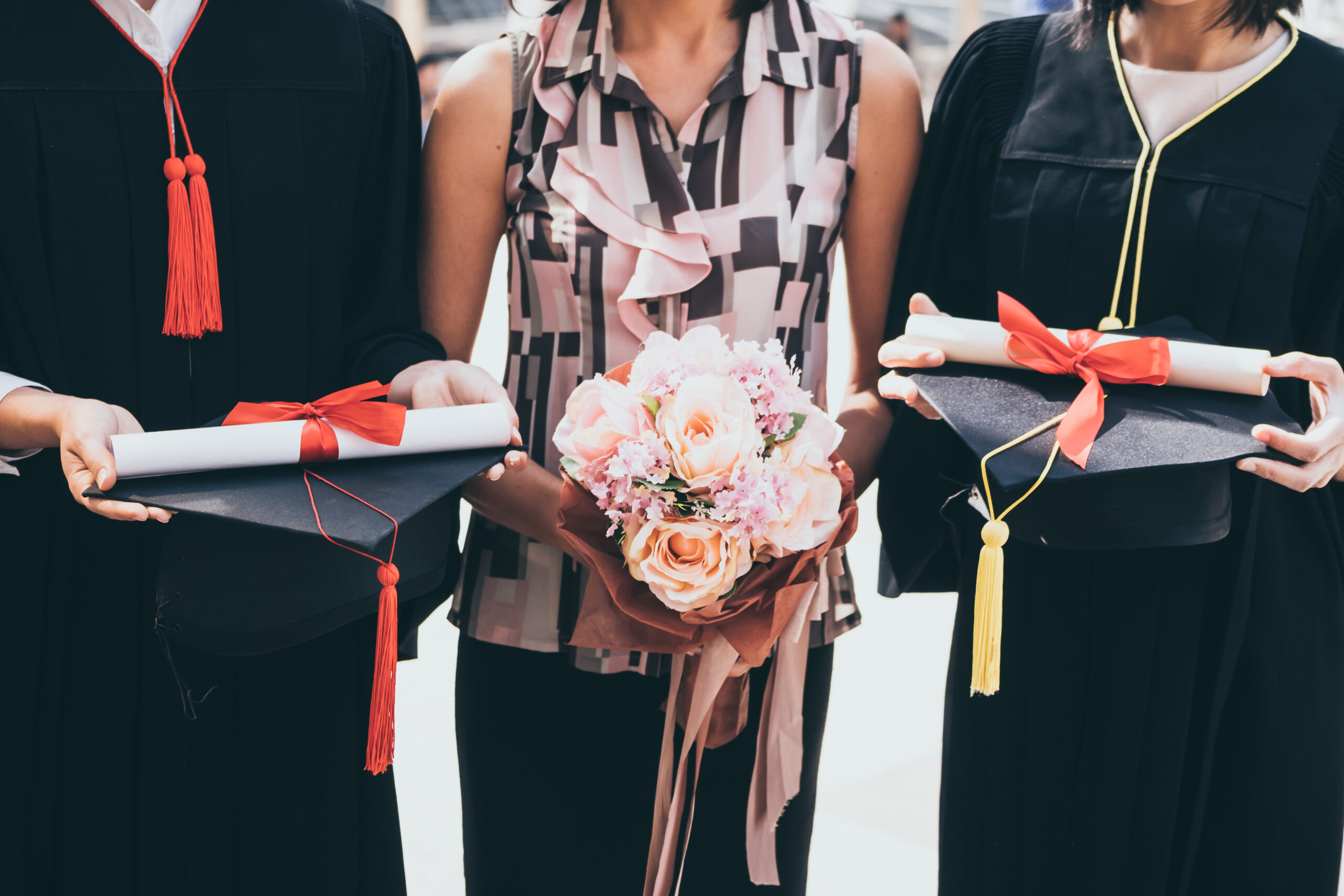 A woman with bouquet congratulates for her family on graduation day, Successful concept